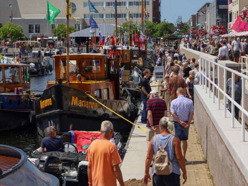 Een volle aanlopohaven in Zeewolde, op het water met bootjes, aan de kant met publiek en kraampjes